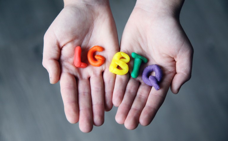 Hands holding coloured playdoh LGBTQ